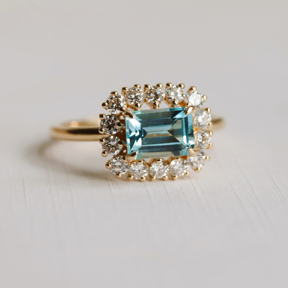Emma | 1 ct. Emerald Cut Sky Blue Topaz East West Halo Ring